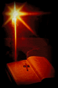 bible on table lit by candle