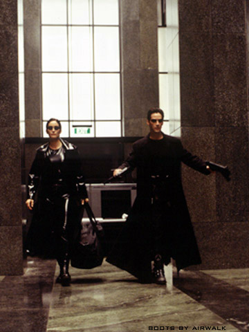 Neo and Trinity, packing alot of heat, enter the building and inflict much damage in the greatest movie scene ever.