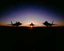 Three F-22's at sunset.