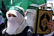 Muslims, one is holding the Koran