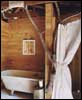 A camp bathroom with an ingenious shower curtain rod