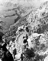 FLOYD GIBBONS & PARTY ON MULES ASCENDING THE S KAIBAB TRAIL. TONTO PLATEAU BEYOND. 02 SEP 1932. NPS.