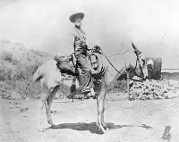 LOUIS BOUCHER, THE HERMIT THAT HERMIT CAMP AND TRAIL WERE NAMED AFTER, SITS ON HIS MULE, SILVER BELL. CIRCA 1910. PHOTO BY MURPHY, E.W.