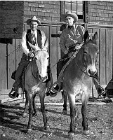 E.M (CURLEY) ENNIS (AT LEFT) SHU'T OF THE SANTA FE TRANSPORTATION COMPANY FOR FRED HARVEY AND HIS TRAIL FOREMAN, JOHN BRADLEY, READY FOR AN INSPECTION TRIP ALONG THE BRIGHT ANGEL TRAIL BY MULE. CIRCA 1948. SANTA FE RR, LA 5233-29