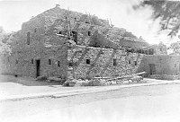 ENTRANCE SIDE OF HOPI HOUSE, NO PEOPLE, N WALL VISIBLE. CEMENT SIDEWALK. GRCA 36042. CIRCA 1930. NPS. 