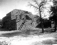 EXTERIOR VIEW OF HOPI HOUSE WITH LADDERS. METATES LEANING AGAINST BUILDING. GRCA 27532<br>CIRCA 1905. DETROIT PHOTOGRAPHIC 