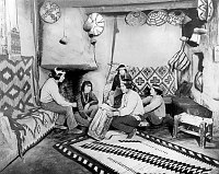 FIVE NATIVE MEN DRUMMING & CHANTING IN A HOPI HOUSE RETAIL SHOWROOM. HIGHLY RETOUCHED IMAGE. CIRCA 1905. FRED HARVEY. 