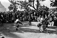 INDIAN DANCERS AT HOPI HOUSE - BEFORE ELEVATED DANCE PLATFORM. VISITOR CROWD. CIRCA 1927. NPS PHOTO.