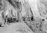 RIVER TRAIL CONSTRUCTION. CCC ENROLLEES WORKING WITH COMPRESSOR ON TRAIL. MAKESHIFT TABLE. CIRCA 1935. NPS PHOTO