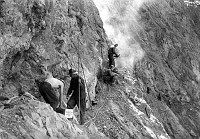 CONSTRUCTION OF RIVER TRAIL BY CCC ENROLLEES. ENROLLEES WORKING ON LEDGE. BLASTING AREA. CIRCA 1935. NPS