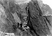 CONSTRUCTION OF RIVER TRAIL BY CCC ENROLLEES. BLASTING. COMPRESSOR LINES. CIRCA 1935. NPS. <br><br>