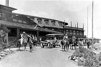 VARIETY OF VISITORS & HORSES BY FRONT ENTRANCE TO EL TOVAR HOTEL. TOURING CARS. CIRCA 1922. FRED HARVEY PHOTO