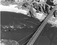 VIEW FROM THE SOUTH SIDE OF THE COLORADO RIVER LOOKING DOWN ON THE BLACK BRIDGE, KAIBAB TRAIL. 19 JUNE 1963. NPS, WOLFE