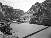 BOTH 1921 SWINGING BRIDGE AND 1928 KAIBAB SUSPENSION BRIDGES OVER THE COLORADO RIVER. (BEFORE ORIGINAL BRIDGE REMOVED.) CIRCA 1928. KEMP, FRED HARVEY CO. 