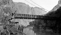 1928 KAIBAB SUSPENSION BRIDGE FROM NOTH SIDE. VIEW UP RIVER.  Circa 1929