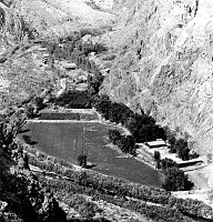 VIEW N UP BRIGHT ANGEL CANYON AND AT PHANTOM RANCH. CULTIVATED FIELD WITH LODGE AND CABINS BEYOND. CIRCA 1933. NPS. 