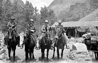 MULE PARTY OF A. PACK & W. FINLEY OF NATURE MAGAZINE AT PHANTOM RANCH. POOL HOUSE BEHIND. CIRCA 1930. NPS, MCKEE.