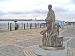 the anonymous sculptures on the walkway at the Pier head