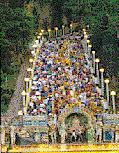 Indian devotees in picture left  climbing the majestic stairs in Batu Caves during Thaipusam festival